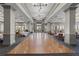 Spacious ballroom featuring hardwood floors, elegant lighting, and ample room for events at 5599 Hidden Oak Ct, North Port, FL 34287