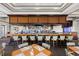 Upscale bar area featuring ample seating and mirrored backdrop with liquor displays at Heron Creek Golf & Country Club at 5599 Hidden Oak Ct, North Port, FL 34287