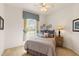 Comfortable bedroom with a window, decorative wall art, and a cozy bed with pillows at 5599 Hidden Oak Ct, North Port, FL 34287