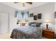 Comfortable bedroom with carpet, two windows with valances and a bedside table at 5599 Hidden Oak Ct, North Port, FL 34287