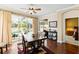 Dining area with sliding glass doors overlooking the pool, next to the living room and bedroom at 5599 Hidden Oak Ct, North Port, FL 34287