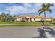 Charming single-story home featuring a tile roof, well-manicured lawn, and lush landscaping at 5599 Hidden Oak Ct, North Port, FL 34287