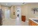 Hallway with tiled floors and an arched entryway visible from the kitchen area at 5599 Hidden Oak Ct, North Port, FL 34287