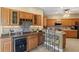 Well-equipped kitchen with a wine cooler, bar seating, and ample counter space for cooking and entertaining at 5599 Hidden Oak Ct, North Port, FL 34287