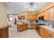 Well-lit kitchen featuring stainless steel appliances, wood cabinetry, and a ceiling fan with lighting at 5599 Hidden Oak Ct, North Port, FL 34287