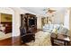 Comfortable living room featuring hardwood floors, a ceiling fan, and plush seating near the dining nook at 5599 Hidden Oak Ct, North Port, FL 34287