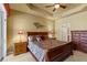 Main bedroom features a tray ceiling, carpet, furniture and a glass door with access to the pool area at 5599 Hidden Oak Ct, North Port, FL 34287
