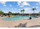 Relaxing pool with water feature surrounded by lush greenery at Heron Creek Golf & Country Club at 5599 Hidden Oak Ct, North Port, FL 34287