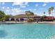 Resort-style pool with ample seating and lush landscaping at Heron Creek Golf & Country Club at 5599 Hidden Oak Ct, North Port, FL 34287