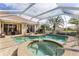 Beautiful screened-in pool area with a luxurious in-ground pool and spa for relaxing and entertaining at 5599 Hidden Oak Ct, North Port, FL 34287
