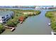 Aerial view featuring condo with dock access to waterway, set amidst lush mangroves and scenic coastal landscape at 9874 Indian Key Trl # 62, Seminole, FL 33776