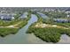 Scenic aerial view of condos nestled among mangrove preserves and the calm waterway at 9874 Indian Key Trl # 62, Seminole, FL 33776