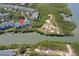 Aerial view of waterfront condominium surrounded by lush mangrove preserves and waterways at 9874 Indian Key Trl # 62, Seminole, FL 33776