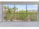 Balcony view of lush tropical foliage and partial view of building at 9874 Indian Key Trl # 62, Seminole, FL 33776