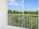 Enjoy lush tropical views from this screened balcony overlooking palm trees and the intercoastal waterway at 9874 Indian Key Trl # 62, Seminole, FL 33776