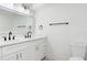 Modern bathroom with double sinks, white cabinets, and granite countertop at 9874 Indian Key Trl # 62, Seminole, FL 33776