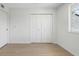 Bright bedroom featuring hardwood floors and large closet at 9874 Indian Key Trl # 62, Seminole, FL 33776