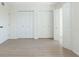 Bright bedroom featuring hardwood floors and two large closets at 9874 Indian Key Trl # 62, Seminole, FL 33776