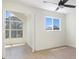 Bright bedroom featuring hardwood floors, ceiling fan and large windows at 9874 Indian Key Trl # 62, Seminole, FL 33776