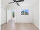 Bright bedroom with light wood floors, large window, and closet at 9874 Indian Key Trl # 62, Seminole, FL 33776