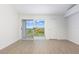 Bright bedroom with wood floors and sliding glass doors to balcony at 9874 Indian Key Trl # 62, Seminole, FL 33776