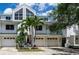 Inviting townhouse with attached garages, lush landscaping, and a modern architectural design at 9874 Indian Key Trl # 62, Seminole, FL 33776