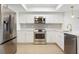 Modern kitchen boasts stainless steel appliances, sleek countertops, and ample cabinet space at 9874 Indian Key Trl # 62, Seminole, FL 33776