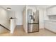 Well-equipped kitchen features stainless steel refrigerator and adjacent staircase at 9874 Indian Key Trl # 62, Seminole, FL 33776