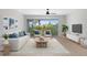Bright living room featuring a modern sofa, balcony, and stylish decor at 9874 Indian Key Trl # 62, Seminole, FL 33776