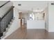 Bright living room with stairs and modern kitchen featuring stainless steel appliances and wood flooring at 9874 Indian Key Trl # 62, Seminole, FL 33776