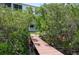 Picturesque walkway to a beautiful home, surrounded by lush greenery and the beauty of nature at 9874 Indian Key Trl # 62, Seminole, FL 33776