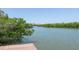 Dock view of the intercostal waterway surrounded by lush mangroves and blue skies at 9874 Indian Key Trl # 62, Seminole, FL 33776