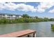 A scenic view of the waterfront surrounded by lush vegetation; condo in the background at 9874 Indian Key Trl # 62, Seminole, FL 33776