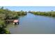 Scenic waterway view featuring lush mangroves, with dock, and picturesque surroundings that enhance the tranquil setting at 9874 Indian Key Trl # 62, Seminole, FL 33776