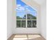 Bright room featuring a triangular window overlooking a beautiful tree-filled landscape at 9874 Indian Key Trl # 62, Seminole, FL 33776