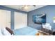 Bedroom with light blue walls, ceiling fan and TV at 10821 Great Carlisle Ct, Riverview, FL 33578