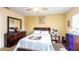 Bedroom with a queen bed, ceiling fan, and matching dresser with a large mirror at 10821 Great Carlisle Ct, Riverview, FL 33578