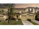 Exterior shot of yellow townhomes with well-maintained lawns at 10821 Great Carlisle Ct, Riverview, FL 33578