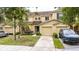 A yellow townhome with an attached garage and landscaping at 10821 Great Carlisle Ct, Riverview, FL 33578