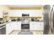 Kitchen with stainless steel oven and white cabinets at 10821 Great Carlisle Ct, Riverview, FL 33578
