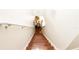 Stairway with wooden stairs leads down to a dining room with a wooden table at 10821 Great Carlisle Ct, Riverview, FL 33578