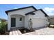 Charming single-Gathering home with a modern architectural style, featuring a well-manicured lawn and a two-car garage at 16833 Fiesta Dr, Port Charlotte, FL 33953