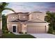 Charming two-story home with a neatly manicured lawn, a two car garage, and tropical landscaping at 16842 Fiesta Dr, Port Charlotte, FL 33953