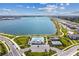 Expansive view of the lakefront community, highlighting the pool, tennis courts, and surrounding residences at 1758 Spreader Ln, Sarasota, FL 34240