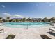 Spacious community pool with lounge chairs, umbrellas, and poolside seating areas, offering relaxation at 18056 Cherished Loop, Bradenton, FL 34211
