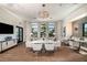 Bright community living room with modern lighting, several tables, and comfortable seating at 18064 Cherished Loop, Bradenton, FL 34211