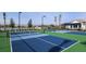 Well-kept community tennis court with a scenic lake view and manicured landscaping at 18064 Cherished Loop, Bradenton, FL 34211