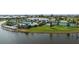Aerial view of the community featuring a pool, clubhouse, lake, tennis courts, and landscaped common areas at 18068 Cherished Loop, Bradenton, FL 34211
