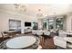 Community clubhouse features multiple seating and game areas, stylish decor, and large windows offering pool views at 18068 Cherished Loop, Bradenton, FL 34211