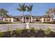 Elegant community clubhouse entrance with palm trees, stone accents and manicured landscaping at 18068 Cherished Loop, Bradenton, FL 34211